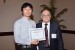 Dr. Nagib Callaos, General Chair, giving Dr. Hidehiro Nakajima the best paper award certificate of the session "Education and Training Systems and Technologies." The title of the awarded paper is "How the Course Management System Affects Faculty Behaviour and Contribute to the Organizational Development."